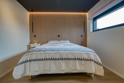 Chambre avec tête de lit en tasseaux de bois rétroéclairés, villa 4 chambres